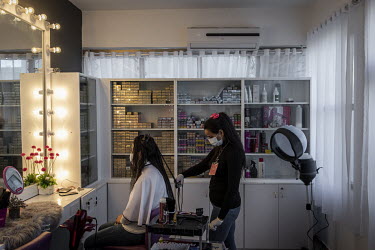 A woman has her hair cut at the at the Menirva Beauty Clinic which was opened in 2016 by Doctor Aya al Masheri after she returned from exile in the US.