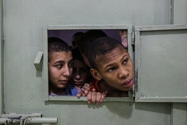 A boy, who introduced himself as Steven Ayatullah (14) from Suriname, peersd out from the crowded prison cell where he is being held, along with over 150 other minors, at a prison for former ISIS memb...