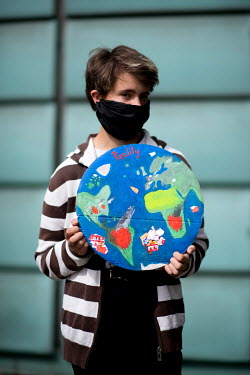 A student environmental activist holds a sign during a protest against the startup of the coal-fired power plant Datteln 4 outside the Finnish Embassy. The Finnish energy group Uniper, operator of the...