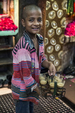 A 'Chai wallah' (tea boy) delivering drinks outside the Nizamuddin Dargah.