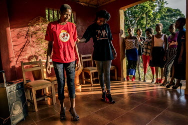 A professional coach, who usually tutors models appearing in fashion shows, teaches the female finalists how to walk with high heels during a training retreat for the Y+ Beauty Contest at a resort on...