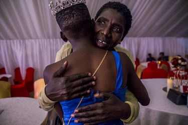 Sherina, a competitor in the Y+ beauty contest, is hugged by her mother, Teopista, who congratulates her daughter for her third place. Sherina learned at age 5 that she had HIV. Her mother, Teopista,...