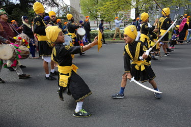 Sikhs boys demonstrating their marshall skills during a parade celebrating the Vaisakhi festival.
