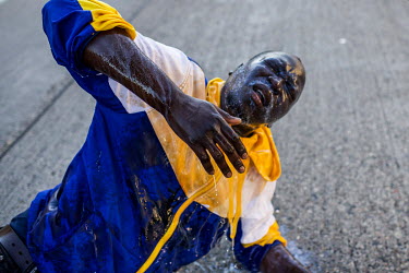 Demonstrators wash a man's face after he was sprayed with mace and pepper by police while taking part in protests that resulted from the killing by the police of George Floyd, an unarmed African-Ameri...