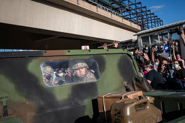 Minnesota National Guards personnel look out from their vehicle, part of a cordon surrounded by demonstrators during protests that resulted from the killing by the police of George Floyd, an unarmed A...