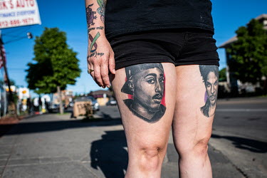 Tattos depicting musicians Tupac Shakur and Prince on the legs of a demonstrator during protests resulting from the killing of an unarmed black man, George Floyd, by police.