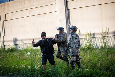 Minnesota national guards push a protestor as they disperse a demonstration during protests and unrest that resulted from the killing by the police of George Floyd, an unarmed African-American.