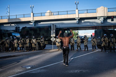 A man approaches a line of National Guards with his hands raised during protests that resulted from the killing by the police of George Floyd, an unarmed African-American.