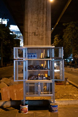A community pantry being installed under an expressway in the Din Daeng district. The community pantry was started by a volunteer group called Little Bricks. Supakit 'Bank' Kulchartvijit said he model...