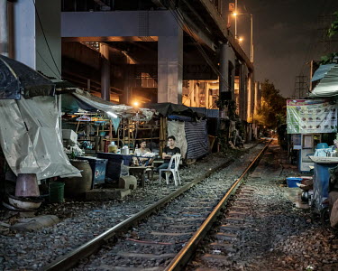 People living in shacks alongside a railway track as the coronavirus lockdown curfew, which runs from 2200 until 0300hrs (as of 25/05/2020), approaches.