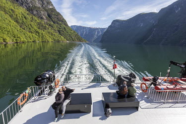 Bjoern Ruud points out something to his wife Orsi Antaloczi, while sitting on the deck of the electric ferry Vision of the Fjords as it sails what is normally the popular route between Flam and Gudvan...