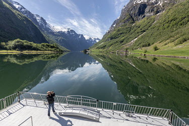 Normally filled with tourists, the entire front deck is free for Agnar Dahl to take pictures from the electric ferry Vision of the Fjords as it sails what is normally the popular route between Flam an...