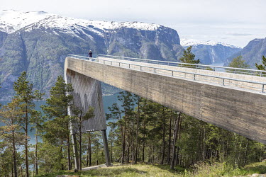 A lone visitor on the Stegastein viewpoint, a 30m viewing platform which sits 650m above the Aurlandsfjord. Normally it would be teeming with people but tourism in Norway has almost come to a complete...