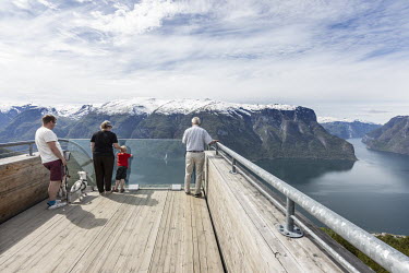 Visitors on the Stegastein viewpoint, a 30m viewing platform which sits 650m above the Aurlandsfjord. Normally it would be teeming with people but tourism in Norway has almost come to a complete stop...