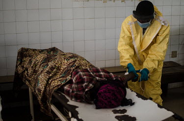 A medical worker prepares to take a sample from a suspected Ebola patient at the Kenema government hospital.