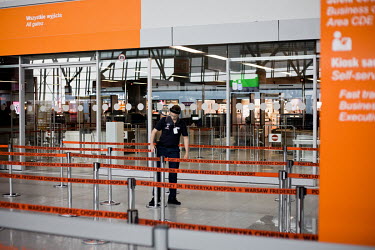 Staff prepare the entrance to Chopin Airport which is commencing with some international flights after they were grounded due to the coronavirus lockdown. On the first day of its reopening the number...
