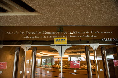 A sign indicates a demarcated exit from the Human Rights Council Chamber. Participants are requested to circulate rooms in a clockwise fashion, and use separate entries and exits. Usually, for securit...