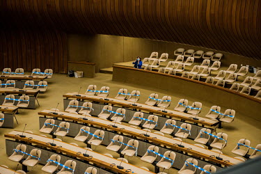 A conference officer taking a break after taping off seats, following a prepared master plan to allow for two metres elbow room for each person in the room. Preparations at the Palais des Nations, the...