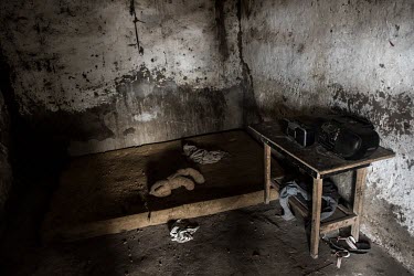 A teddy bear llies in the abandoned bedroom of an Ebola victim.
