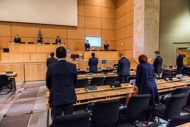 Socially distanced diplomats stand for a minute's silence in memory of victims of racial violence at the opening of a special session of the UN Human Rights Council, an 'Urgent Debate on "Racism and P...