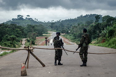 Soldiers guard a road block enforcing a quarantine in two eastern districts during the Ebola outbreak.