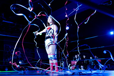 A wrestler salutes the crowd at an Oz Academy Women's Pro-Wrestling competition held at the Shinjuku Face arena.