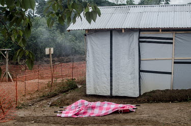 The body of an Ebola victim lies covered on a stretcher at a treatment centre in Kailahn.