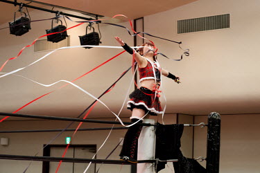 A female wrestler salutes the crowd during a women's wrestling competition held in the Green Hall in the Itabashi district.