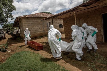 Ebola workers prepare to bury the body of a suspected Ebola victim near Kenema.