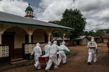 Ebola workers prepare to bury the body of a suspected Ebola victim near Kenema.