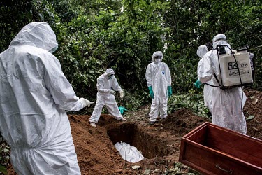 Ebola workers bury the body of a suspected Ebola victim near Kenema.