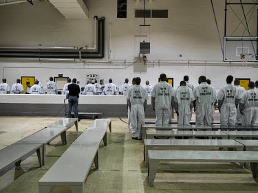 The gymnasium or 'Intake Area', at Georgia Diagnostic and Classification Prison, where new inmates their hair cut, and a medical examination. The barbers are trustees, usually nonviolent inmates incar...