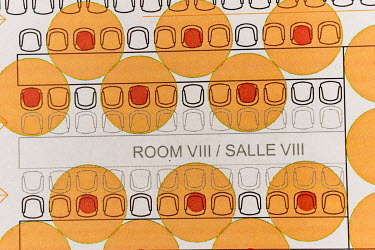 Detail of a plan for a conference room, with most seating blocked to allow each participant to have 2 meters elbow room. Each red dot is a person, and the orange around is the space required. The Pala...