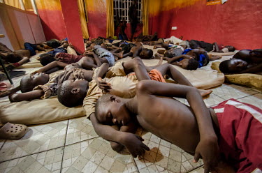 Street children sleep at a homeless shelter run by a charity.