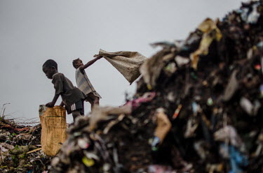 Children collect rubbish to sell on to recylers at a dumping site outside Freetown.