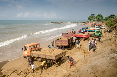 Dozens of trucks are loaded with sand for construction on Hamilton beach, Sierra Leone. Sand mining is seen as a threat to local beaches and coastal communities.