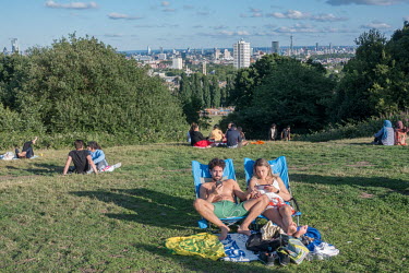 People sunbathing on Hampstead Heath during the weekend of the summer solstice. The government's recommendations on social distancing and limiting gatherings to a maximum of six people were not strict...