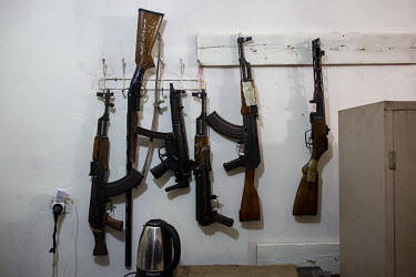 Weapons seized from drug dealers in raids conducted by a specialised police narcotics unit are displayed on the wall at their base.