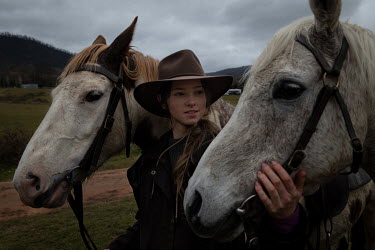 Cara Maguire (19) takes care of two horses after returning from a failed mustering expedition to try and catch wild brumbies (horses) and relocate them at their family property, Mount Bundarra cattle...