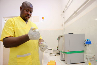 A lab technician at the 'Ceu e Terras' health centre preparing samples of blood for testing for HIV infection and to do CD4 counts.
