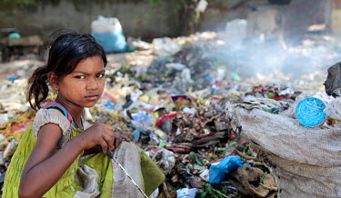 Anara (8) scavenges for recyclable materials from among rubbish dumped near Charbagh Railway Station.