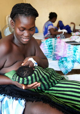 A mother breastfeeds her new born baby on a maternity ward at the Simao Mendez central hospital.