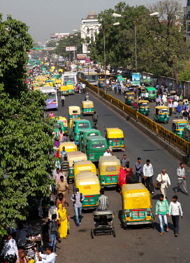 People and traffic on a road near Charbagh Railway Station.