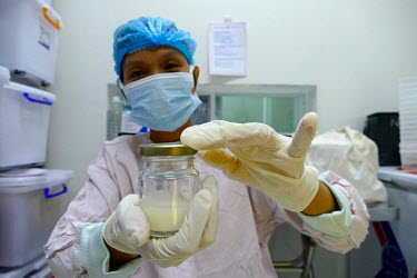 A worker at the Da Nang Human Milk Bank at the Da Nang hospital for women and children prepares portions of expressed milk.