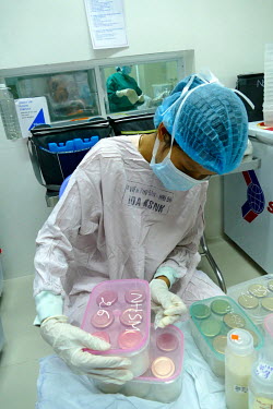 A worker at the Da Nang Human Milk Bank at the Da Nang hospital for women and children prepares portions of expressed milk.