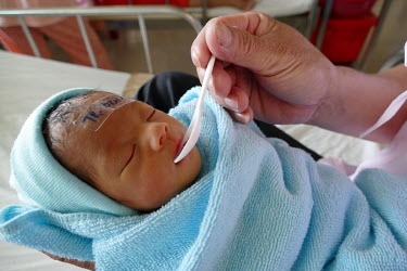 A baby at the Da Nang hospital for women and children is fed with milk from the hospital's milk bank in a maternity ward.