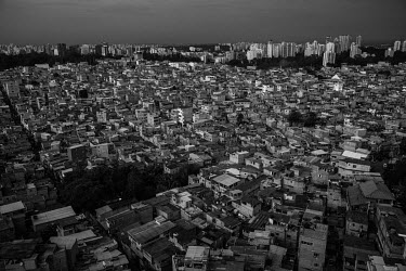 An aerial view of Paraisopolis , one of the biggest favelas of Sao Paulo, located next to Morumbi, one of the wealthiest neighbourhoods in the city.   Luxurious buildings with roof top pools overlook...