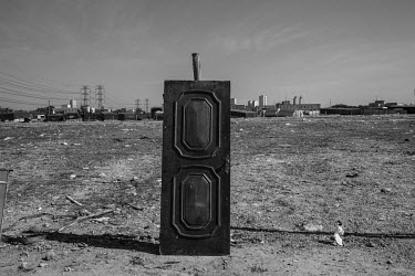 An old door stands leaning against a pole before being used in the construction of a shack in a squatter camp in the northern part of Sao Paulo. This camp has establshed in the past 3 months by people...