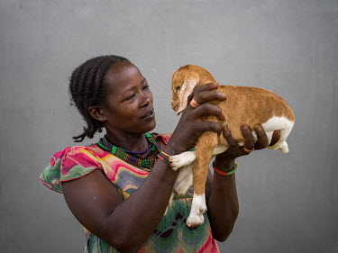 Dawunda Shawkare with a kid goat that she recieved from the Gebinat Goat Breeding Association, a community project breeding goats for village women.