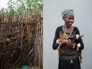 Esther Namoe (25), a Community Animal Health Worker (CAHW) who supports the Women's Livestock Group in Nawakorof B village holding goat kid twins that she is looking after as their mother was stolen i...